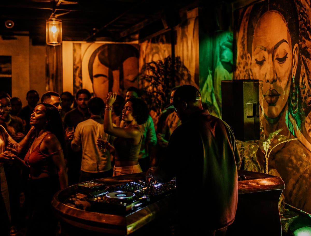 DJ performing at Pablo with a crowd dancing beneath large murals