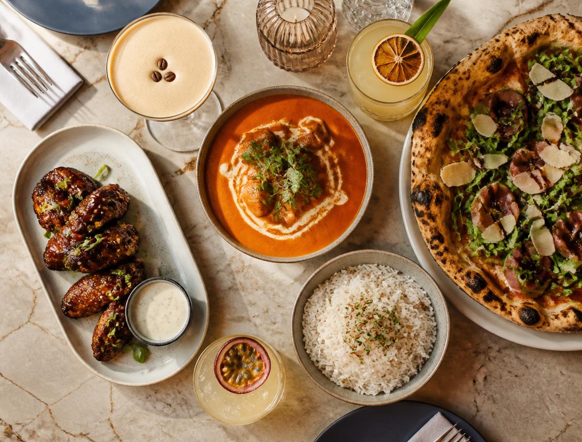 Spread of Pablo's signature dishes and cocktails on a marble table